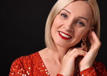 Photo of Smiling woman with perfect makeup on black background