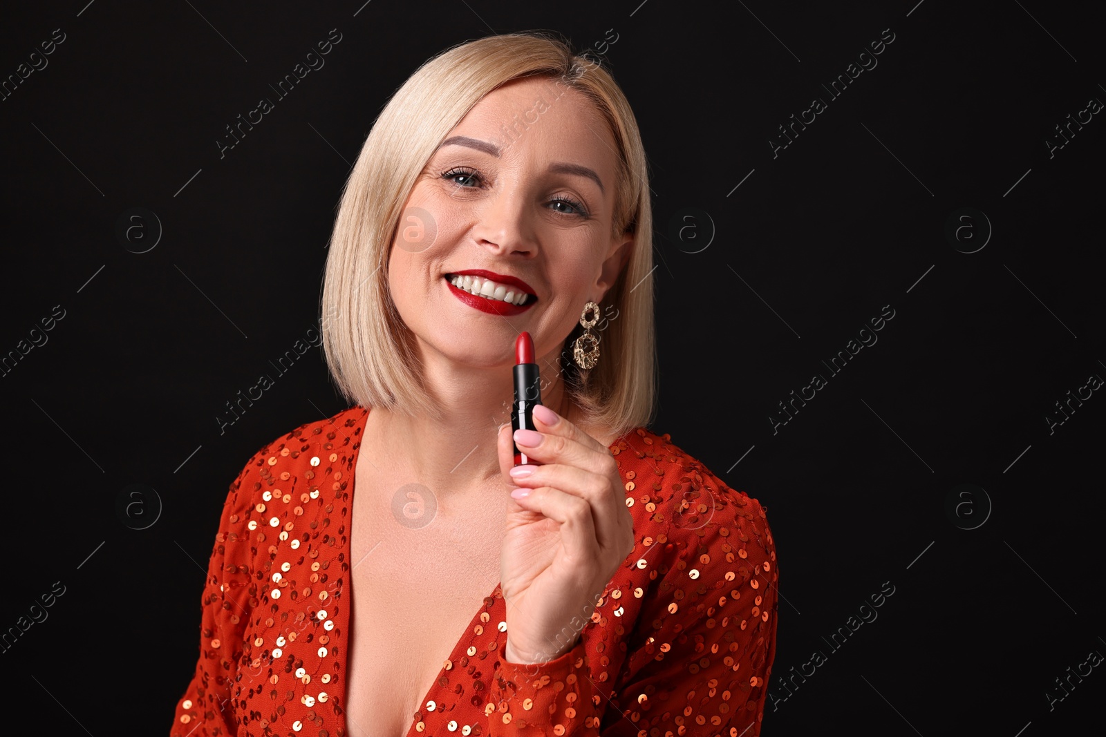 Photo of Smiling woman with red lipstick on black background