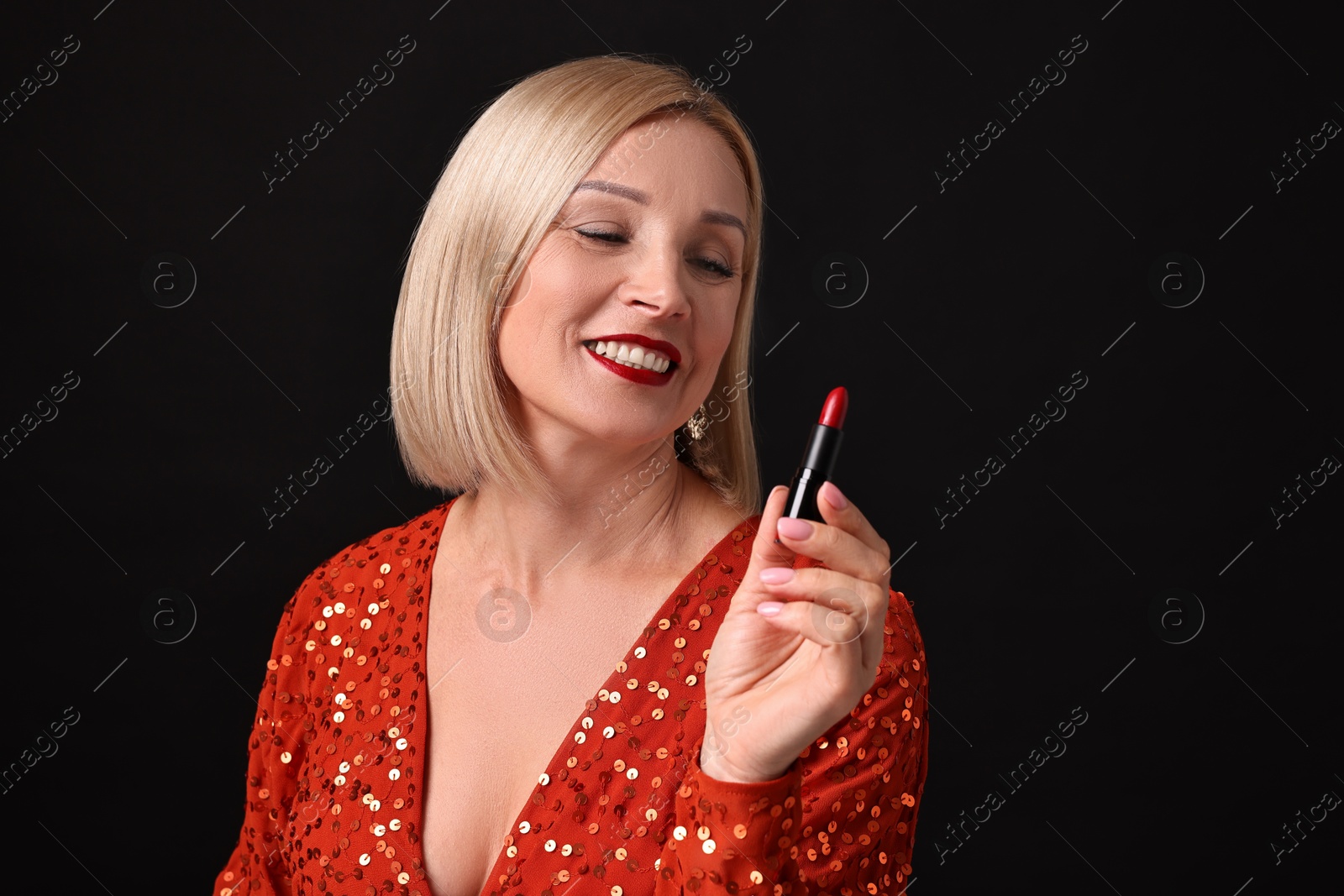 Photo of Smiling woman with red lipstick on black background