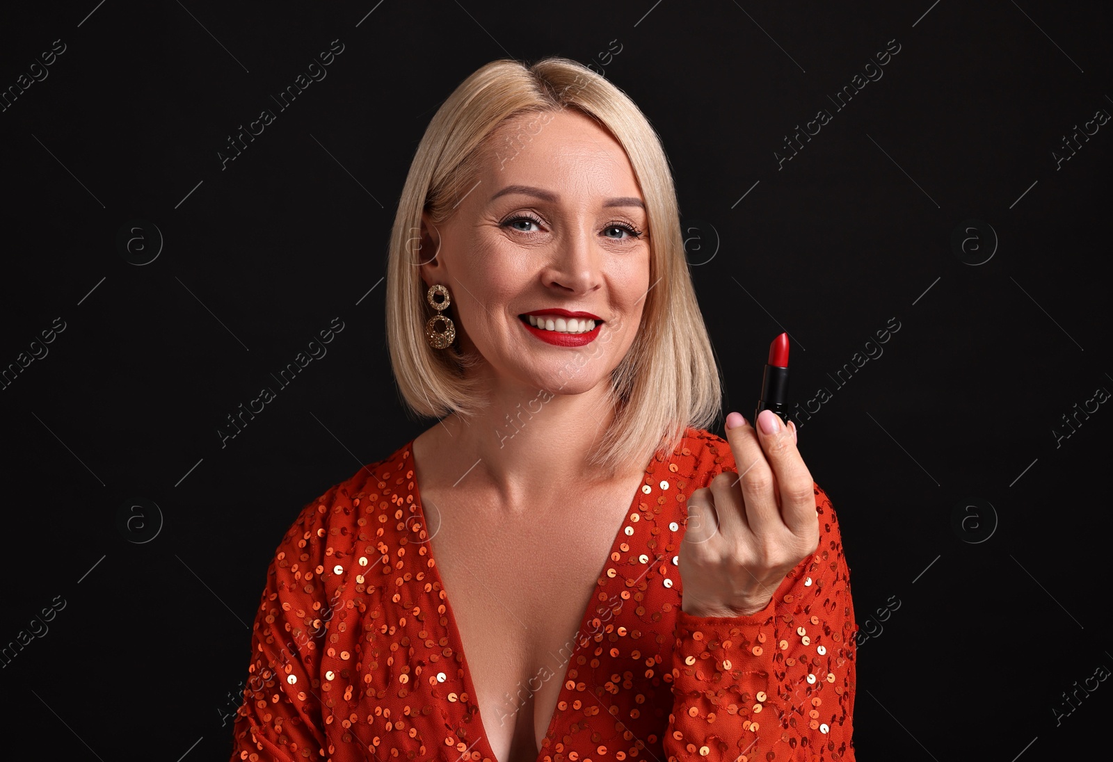 Photo of Smiling woman with red lipstick on black background