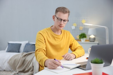 Photo of Student preparing for exam at table indoors