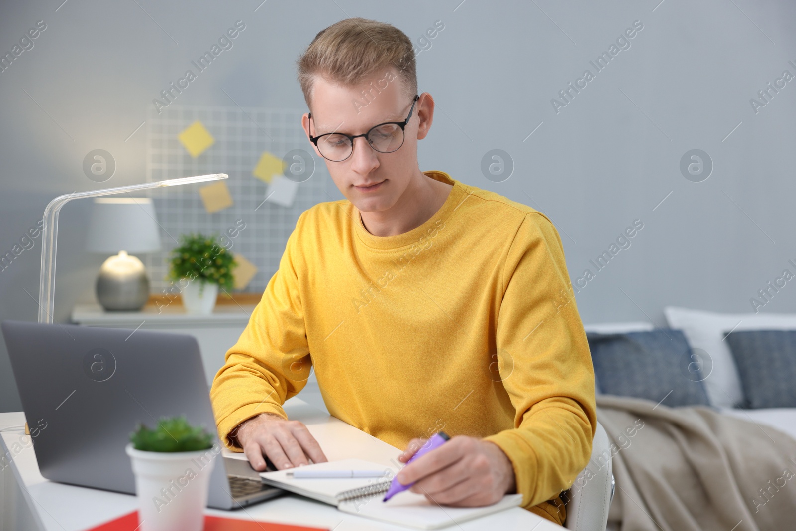 Photo of Student preparing for exam at table indoors