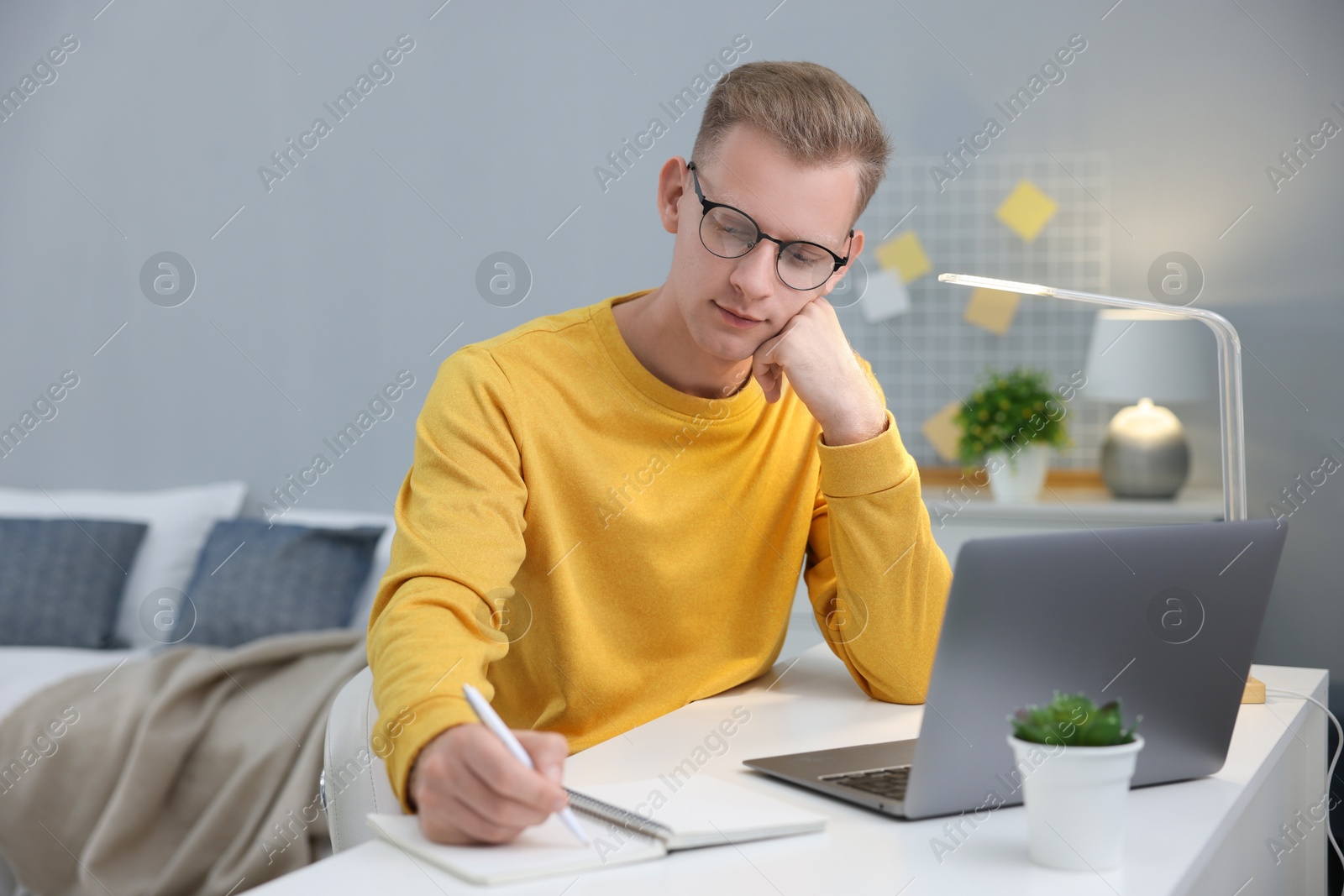 Photo of Student preparing for exam at table indoors