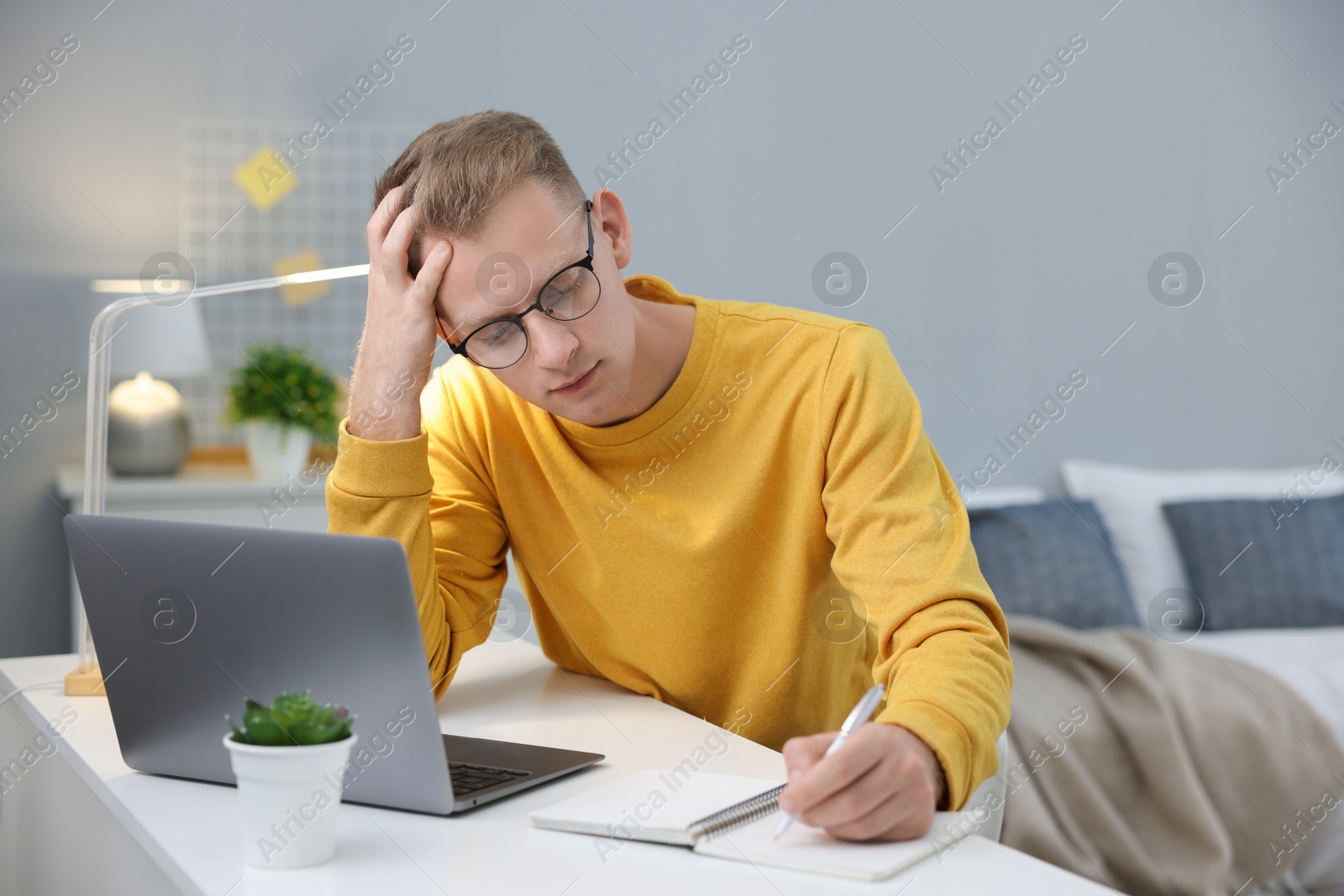 Photo of Student preparing for exam at table indoors