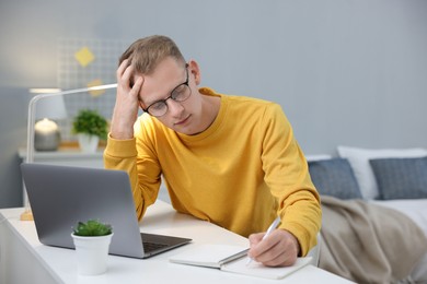 Photo of Student preparing for exam at table indoors