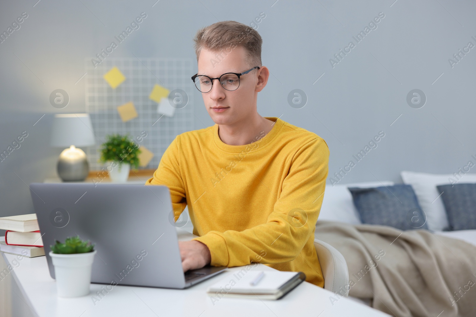 Photo of Student preparing for exam at table indoors