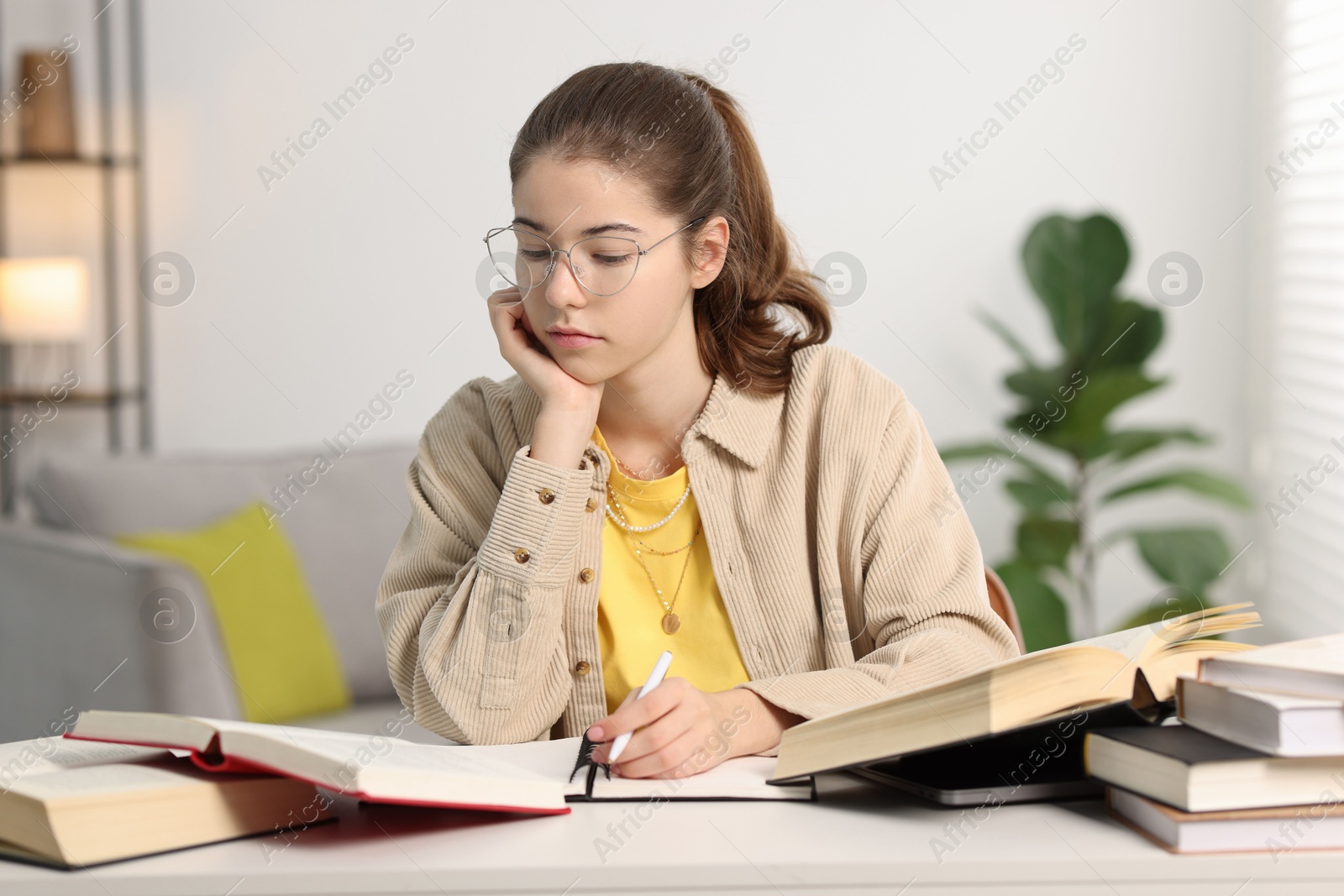 Photo of Student preparing for exam at table indoors