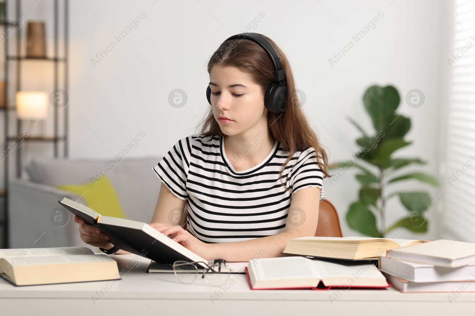 Photo of Student preparing for exam at table indoors