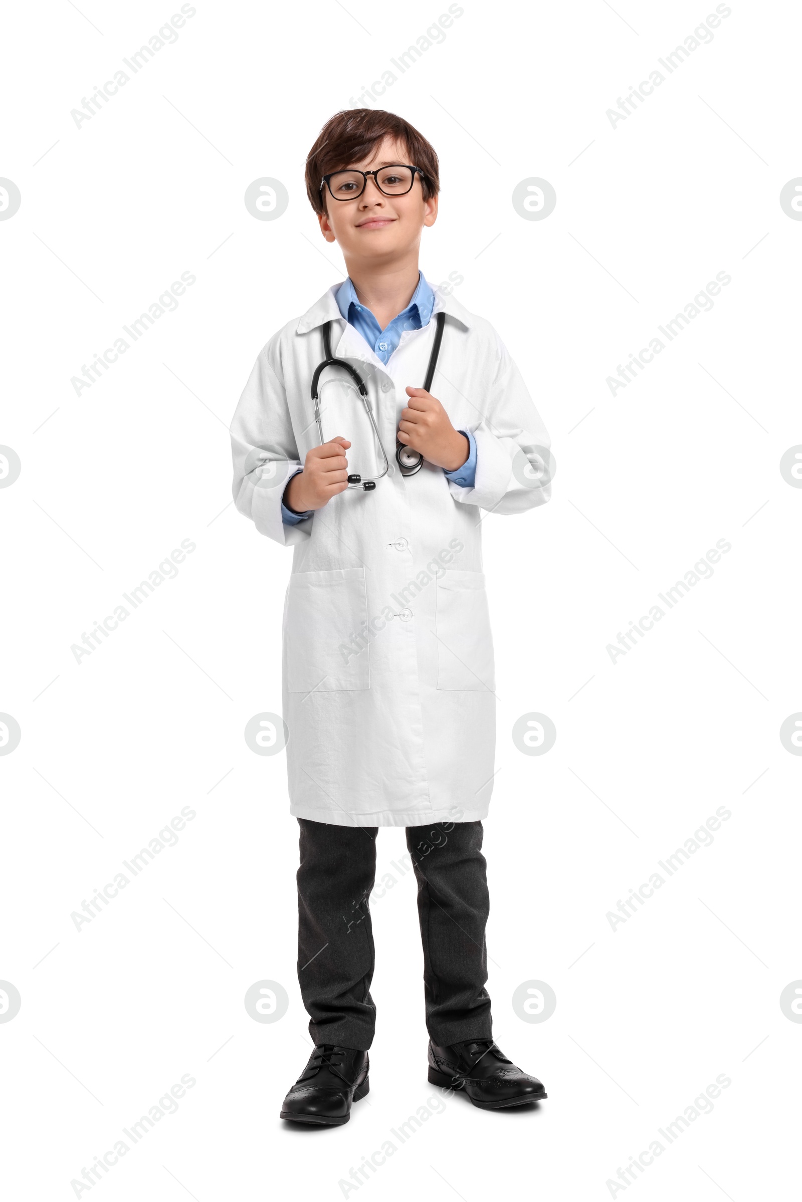 Photo of Boy with stethoscope pretending to be doctor on white background. Dreaming of future profession