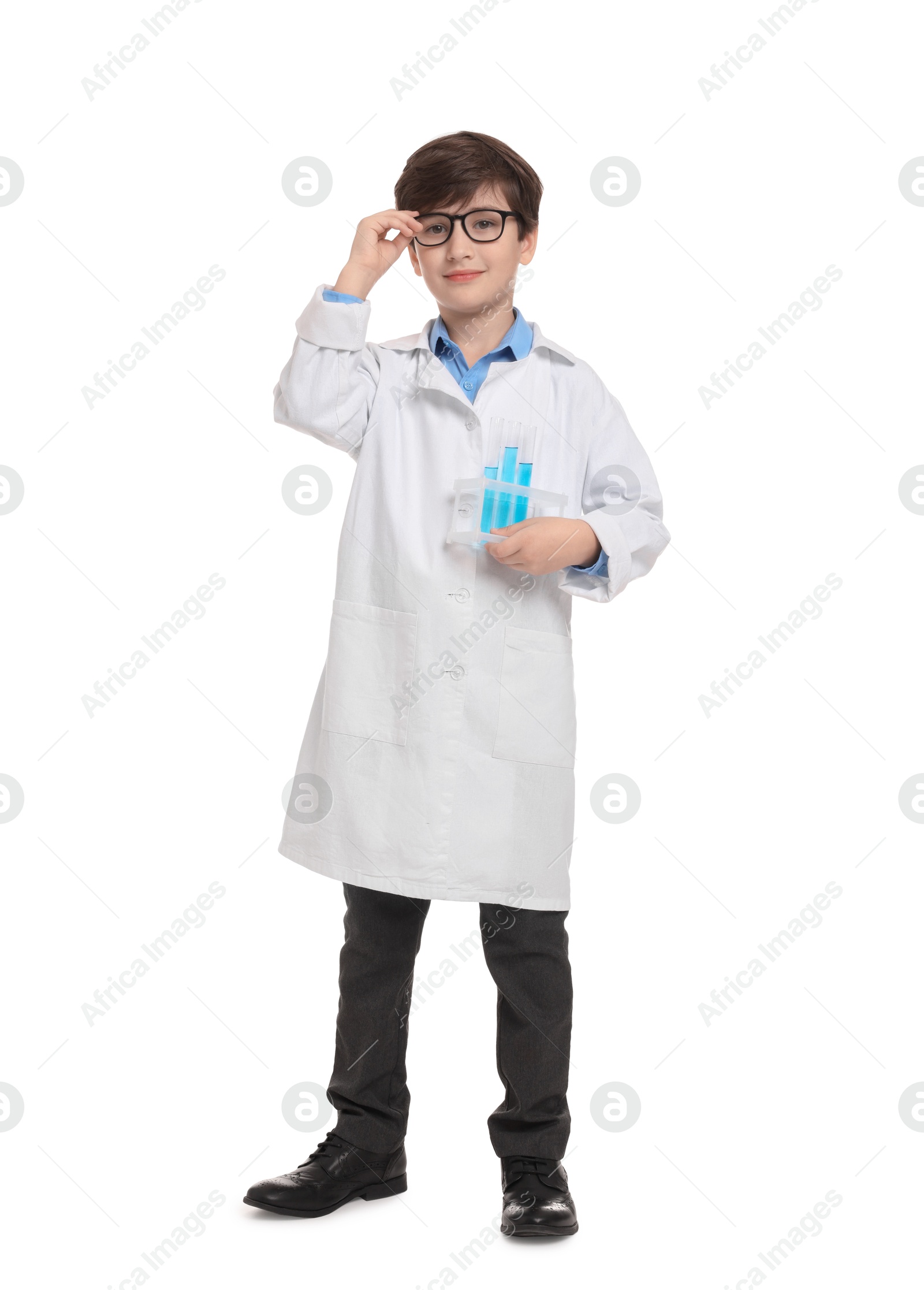 Photo of Boy with test tubes pretending to be scientist on white background. Dreaming of future profession