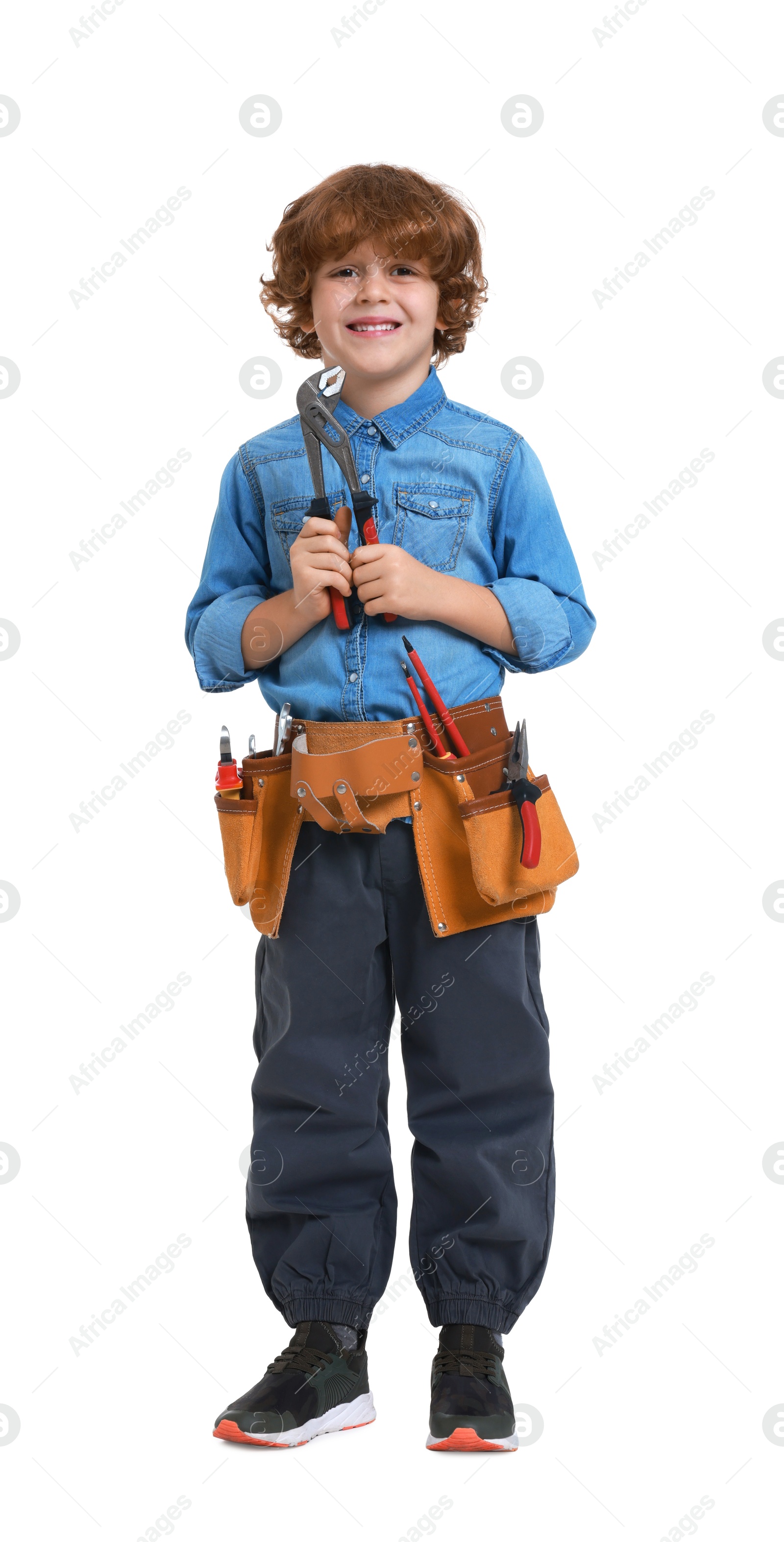 Photo of Little boy with tool belt and adjustable pliers on white background. Dreaming about future profession