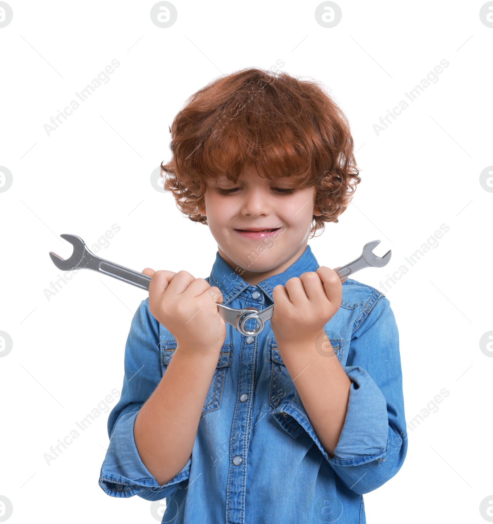 Photo of Little boy with wrenches on white background. Dreaming about future profession