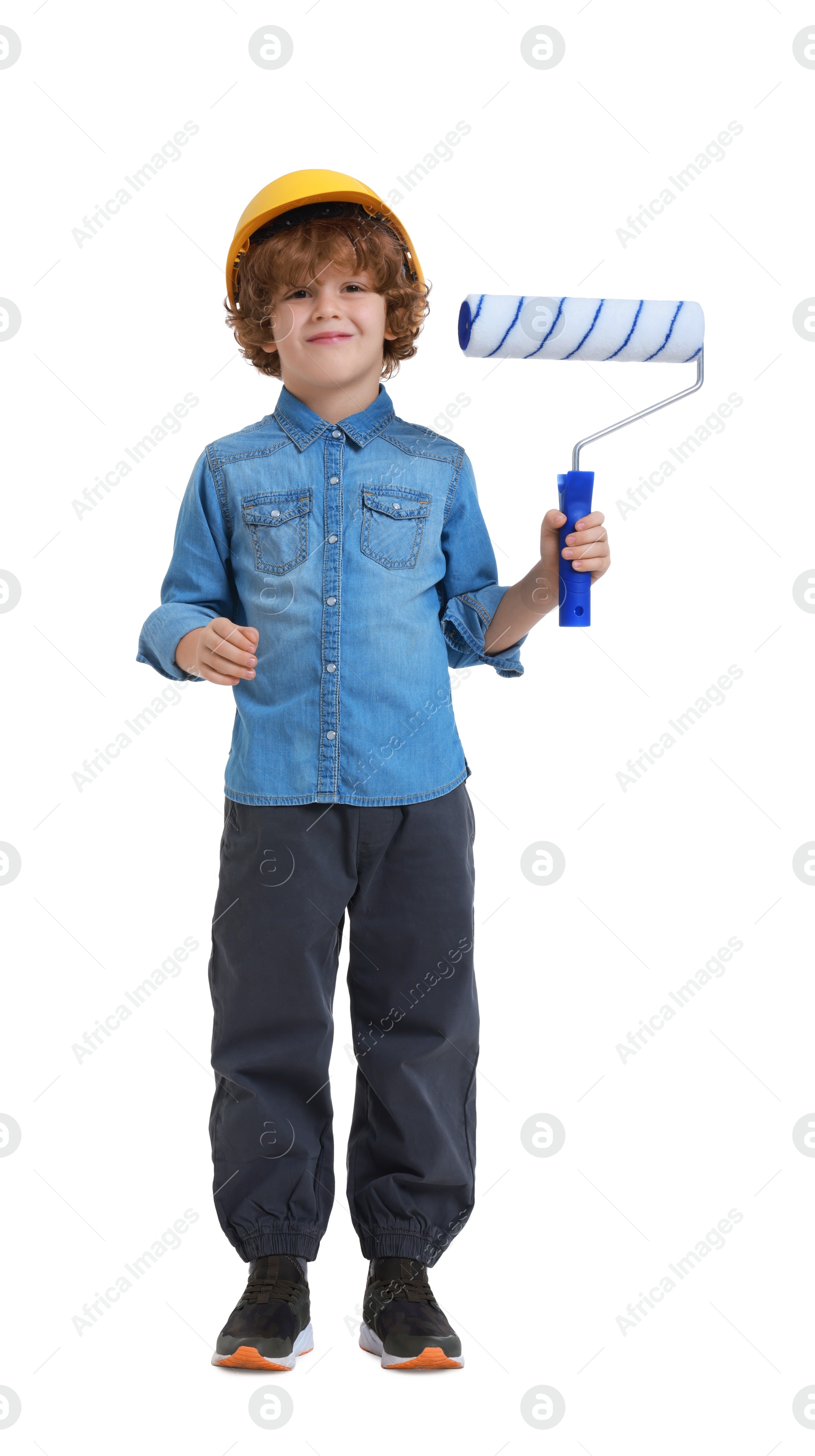 Photo of Little boy in hard hat with roller brush on white background. Dreaming about future profession