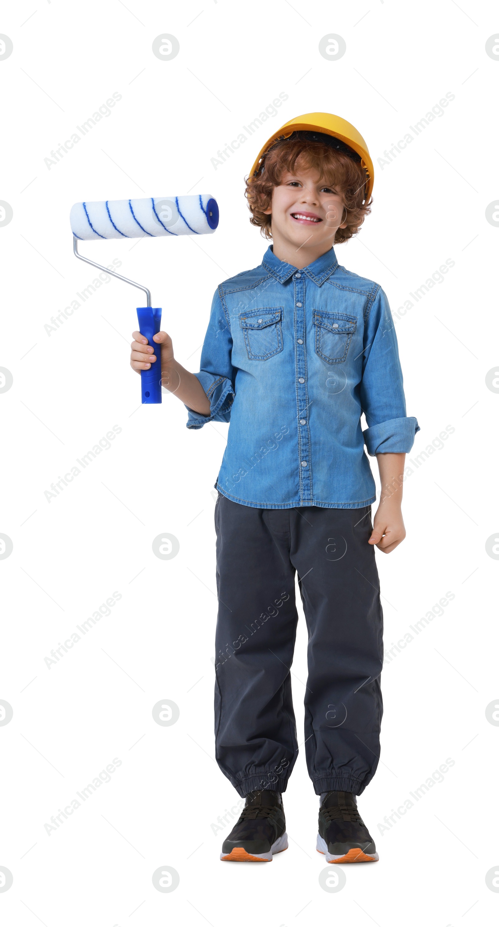 Photo of Little boy in hard hat with roller brush on white background. Dreaming about future profession