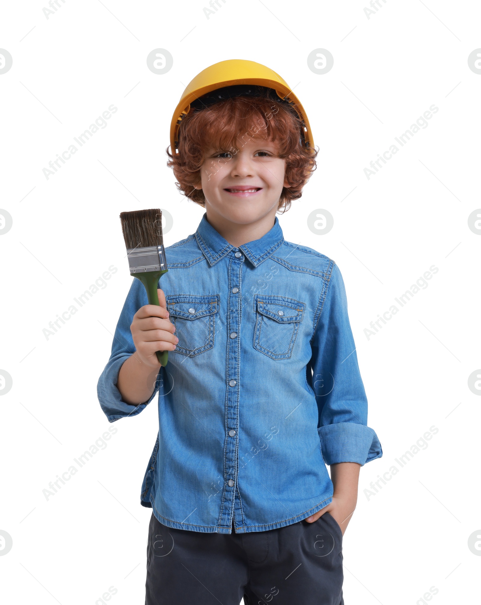 Photo of Little boy in hard hat with paint brush on white background. Dreaming about future profession