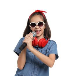 Photo of Girl with sunglasses, headphones and microphone pretending to be singer on white background. Dreaming of future profession