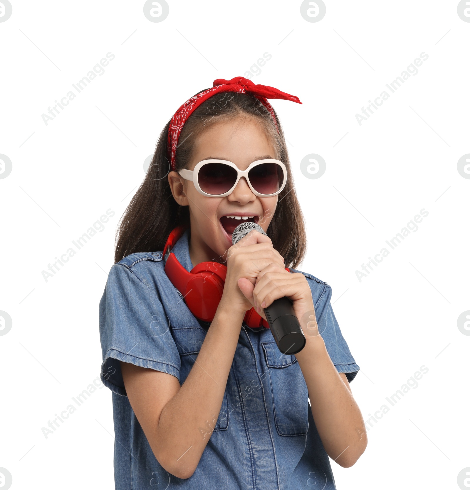 Photo of Girl with sunglasses, headphones and microphone pretending to be singer on white background. Dreaming of future profession