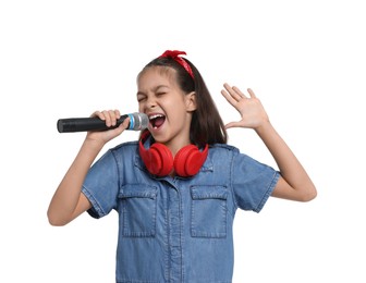 Photo of Girl with headphones and microphone pretending to be singer on white background. Dreaming of future profession