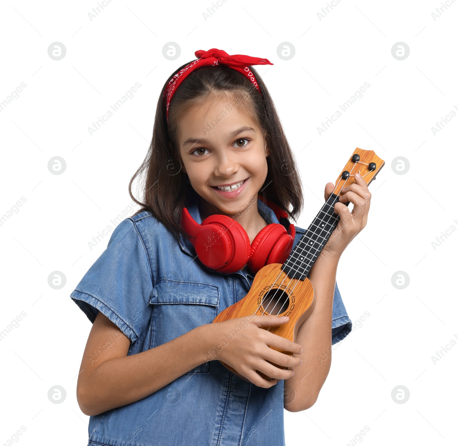 Photo of Girl with headphones and ukulele pretending to be musician on white background. Dreaming of future profession