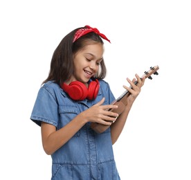 Photo of Girl with headphones and ukulele pretending to be musician on white background. Dreaming of future profession