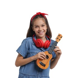 Photo of Girl with headphones and ukulele pretending to be musician on white background. Dreaming of future profession