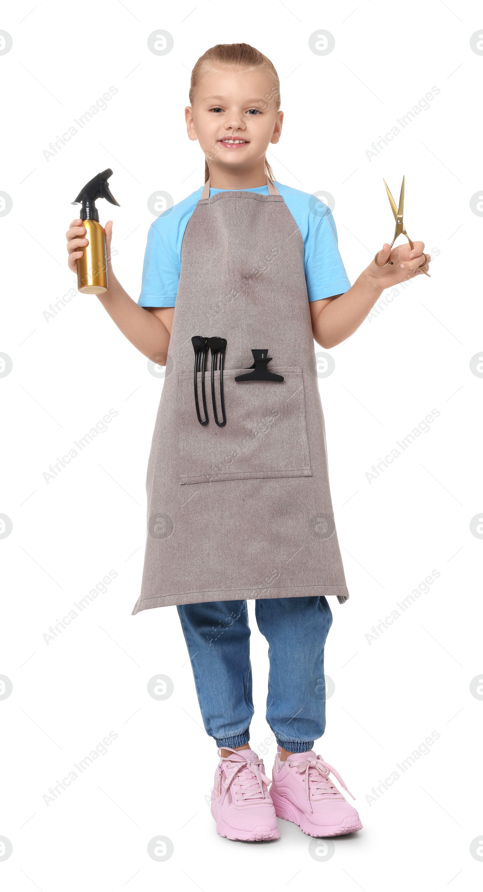 Photo of Little girl with scissors and sprayer pretending to be hairdresser on white background. Dreaming of future profession