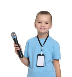 Photo of Little girl with microphone pretending to be journalist on white background. Dreaming of future profession