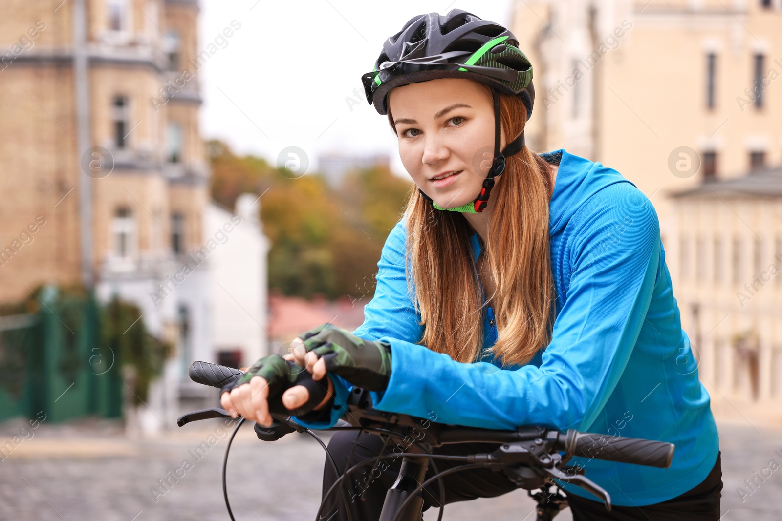 Photo of Woman with helmet and bicycle outdoors. Healthy lifestyle