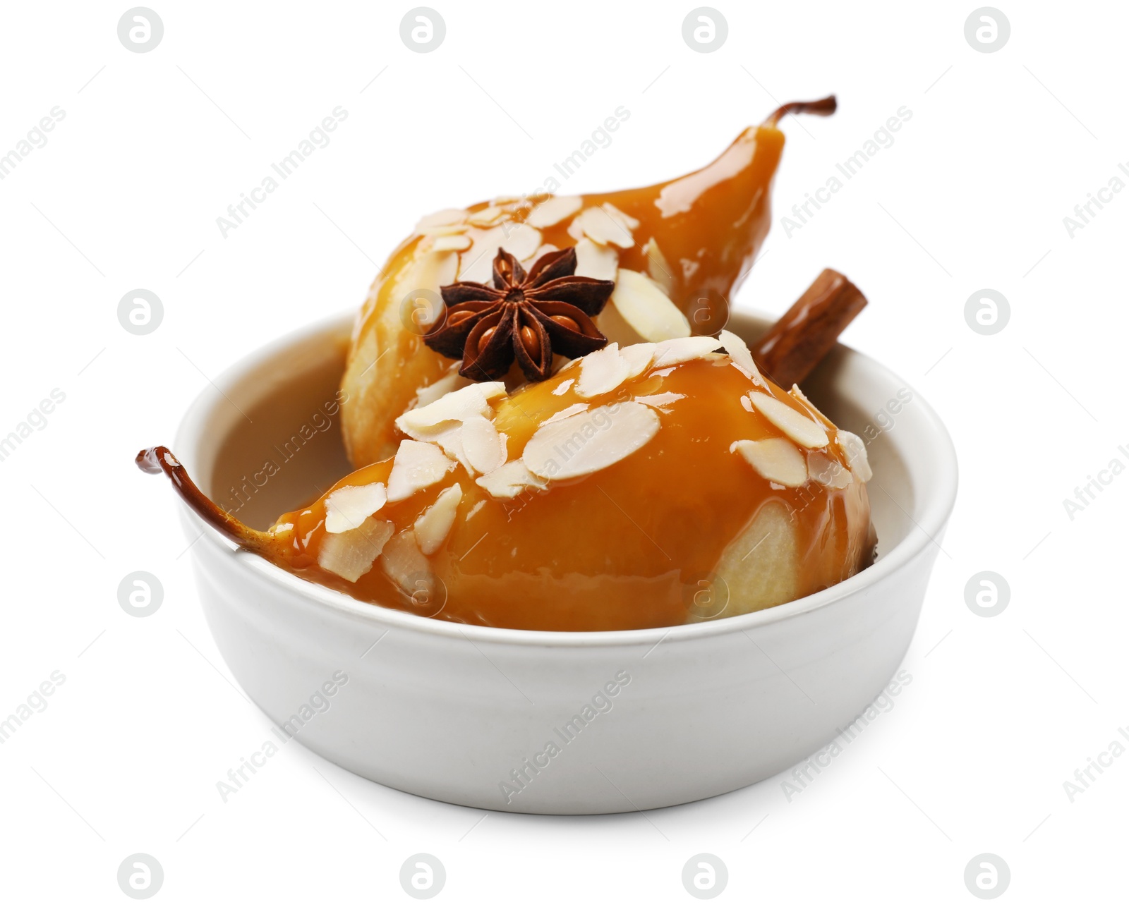 Photo of Delicious pears with caramel sauce, almond flakes and spices isolated on white