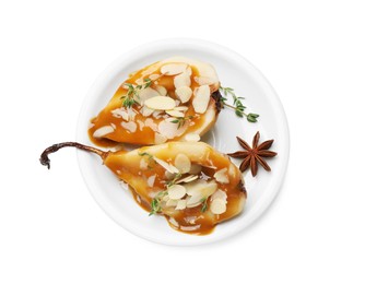 Delicious pears with caramel sauce, almond flakes and spices isolated on white, top view