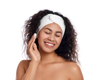 Photo of Beautiful woman applying cream onto face against white background