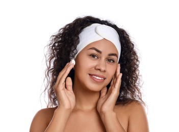 Photo of Beautiful woman applying cream onto face against white background