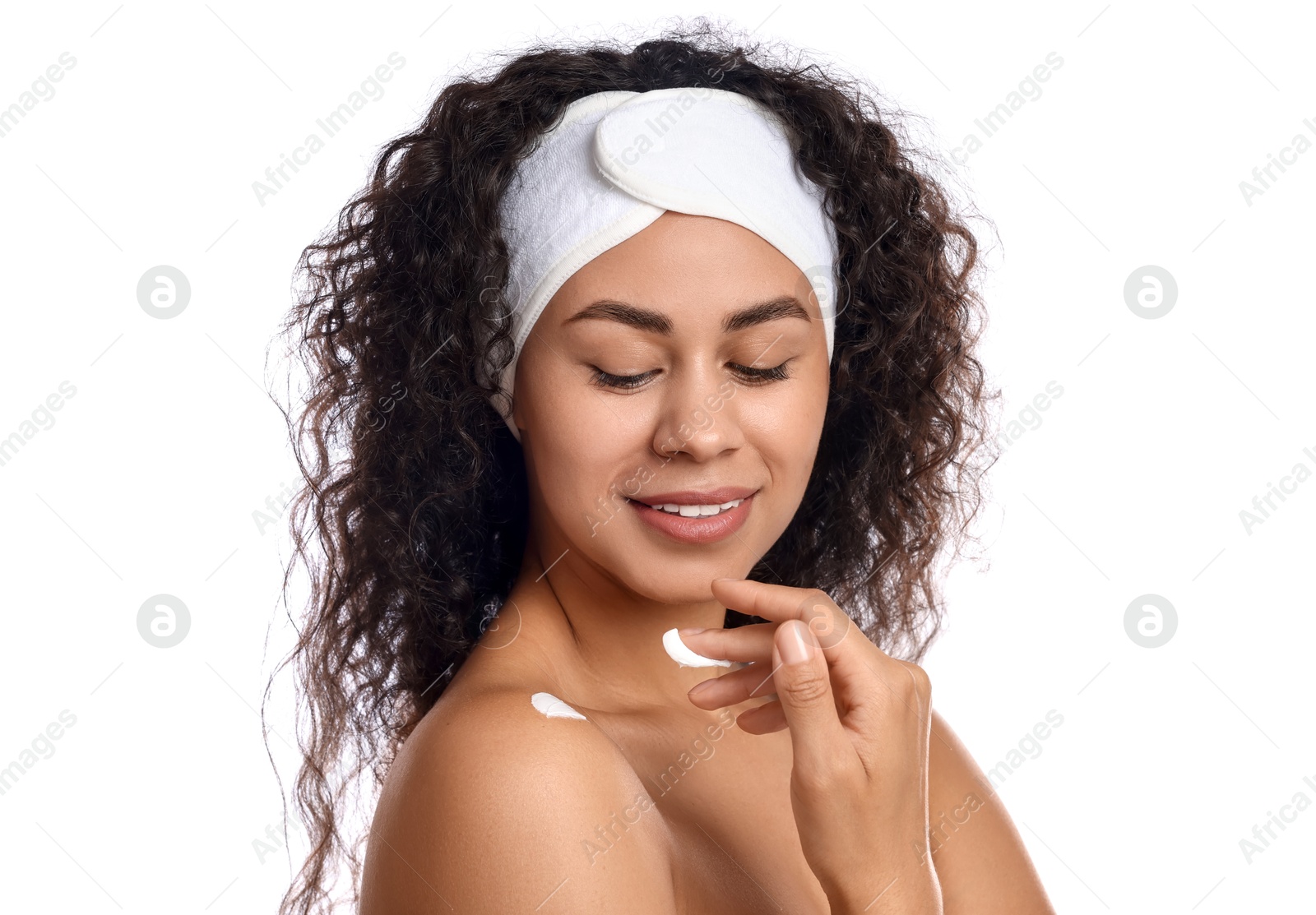 Photo of Beautiful woman applying cream onto shoulder against white background