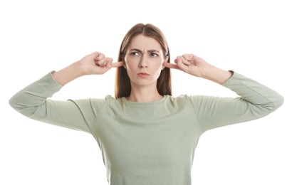 Photo of Woman covering her ears with fingers on white background