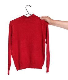 Photo of Woman holding hanger with red long sleeve on white background, closeup