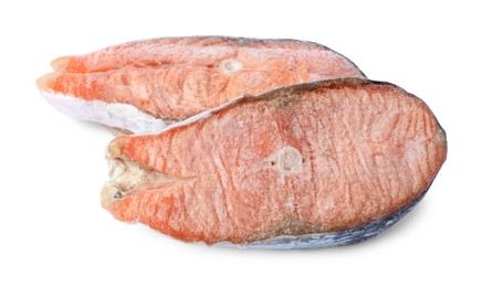 Photo of Two frozen salmon steaks isolated on white