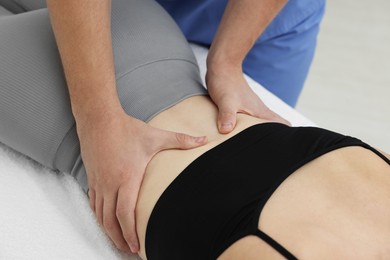 Osteopath massaging woman's back in clinic, closeup. Manual therapy