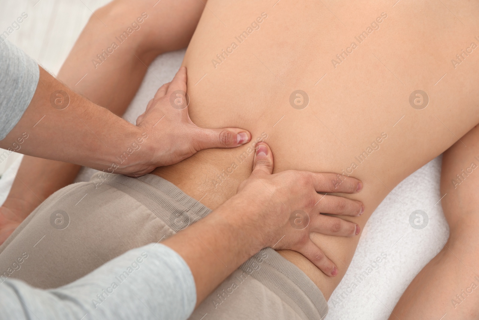 Photo of Massage therapist working with patient in clinic, closeup