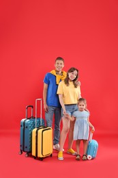 Travellers with suitcases and backpack. Happy family on red background