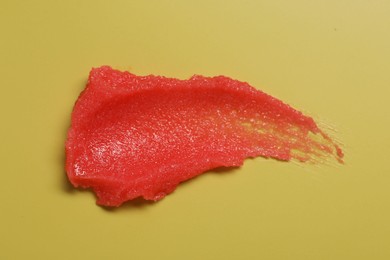 Photo of Sample of body scrub on yellow background, top view