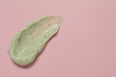 Photo of Smear of body scrub on pink background, top view. Space for text