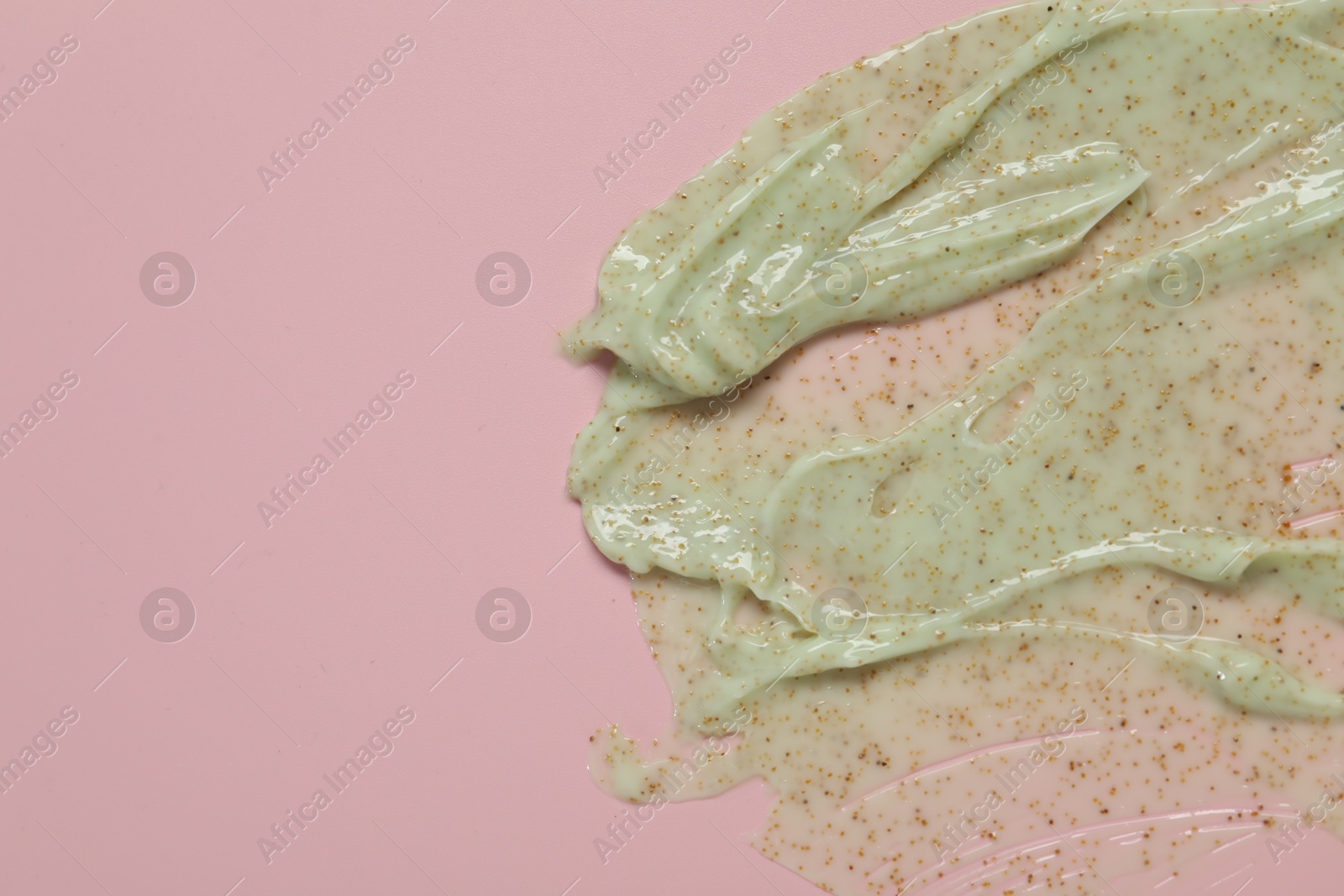 Photo of Sample of body scrub on pink background, top view, Space for text