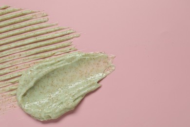 Photo of Samples of body scrub on pink background, top view, Space for text