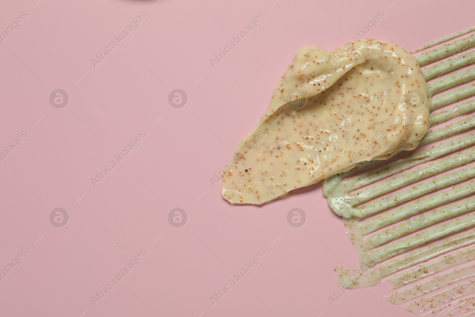 Photo of Samples of different body scrubs on pink background, top view. Space for text