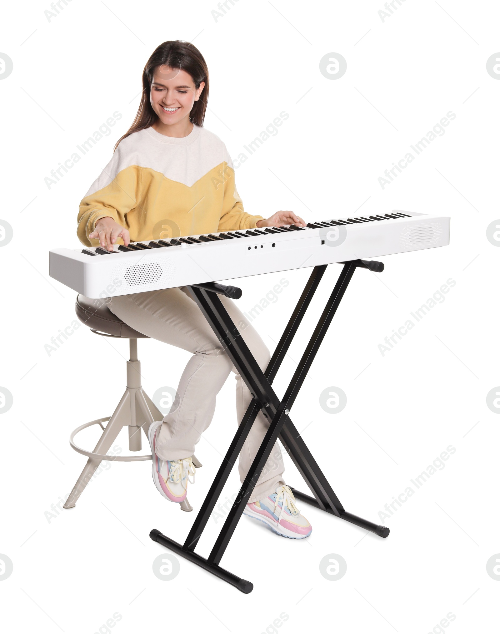 Photo of Smiling woman playing synthesizer on white background