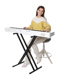 Photo of Smiling woman playing synthesizer on white background