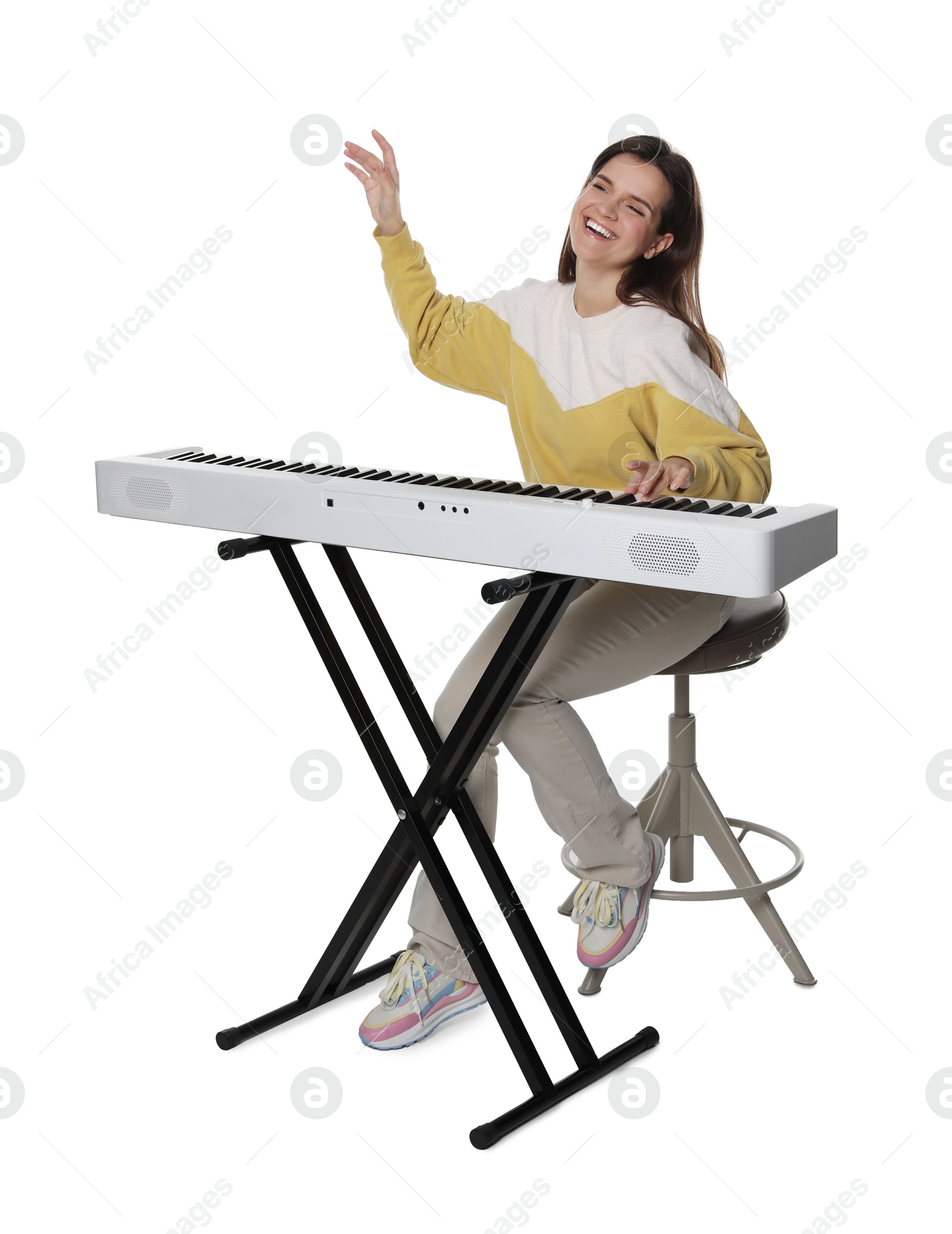 Photo of Smiling woman playing synthesizer on white background