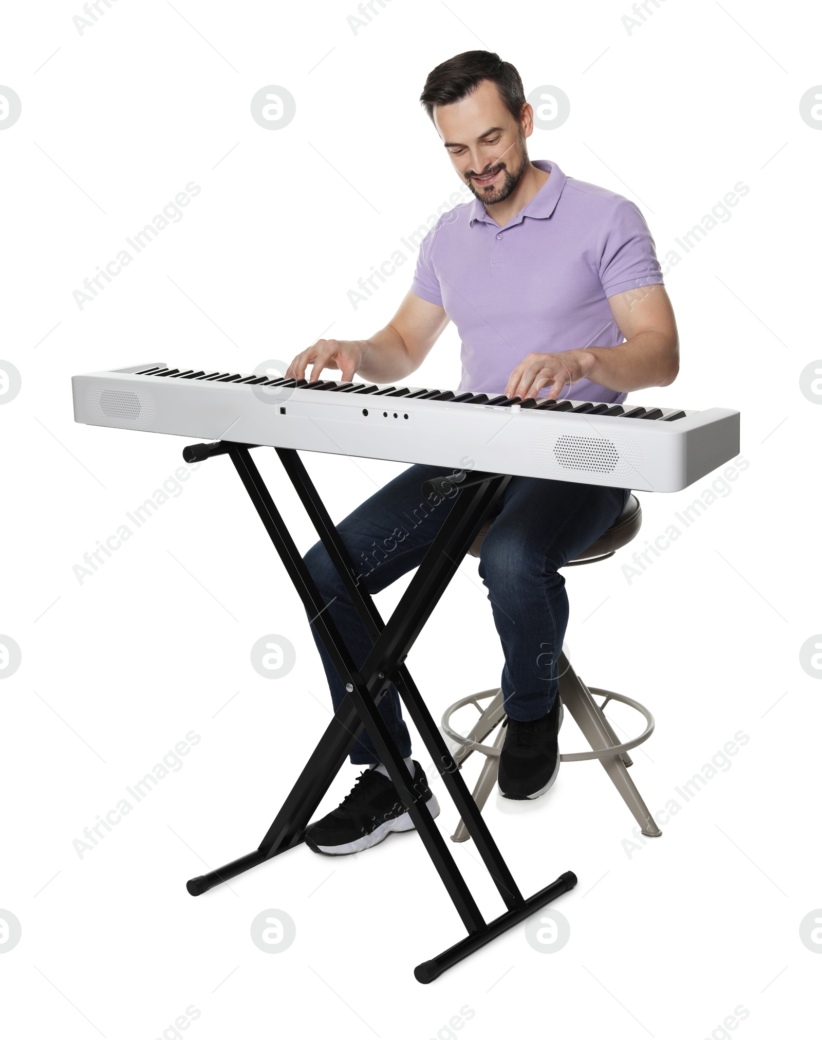 Photo of Bearded man playing synthesizer on white background