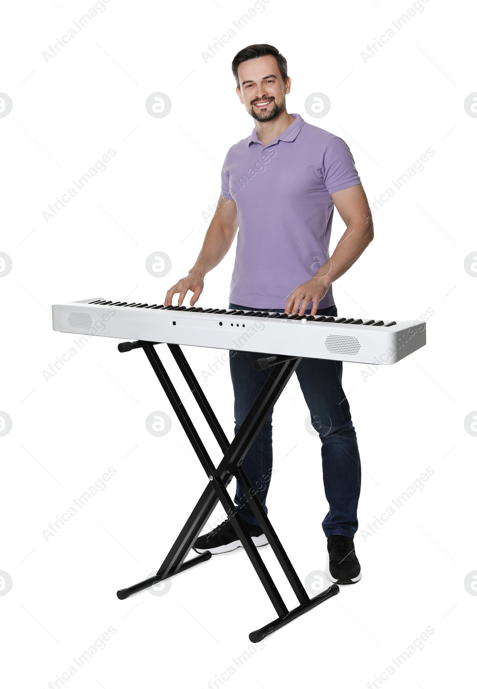 Photo of Smiling man playing synthesizer on white background