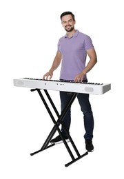 Photo of Smiling man playing synthesizer on white background